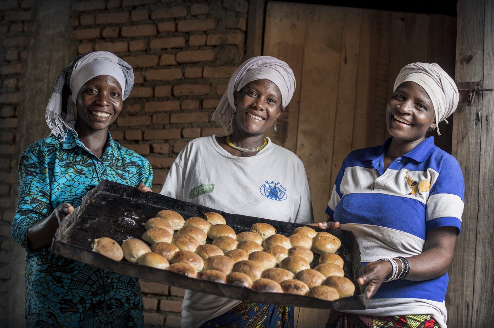 Esperance, Agripina and another baker from the Women's Union of Gitaza with some of the bread they baked.